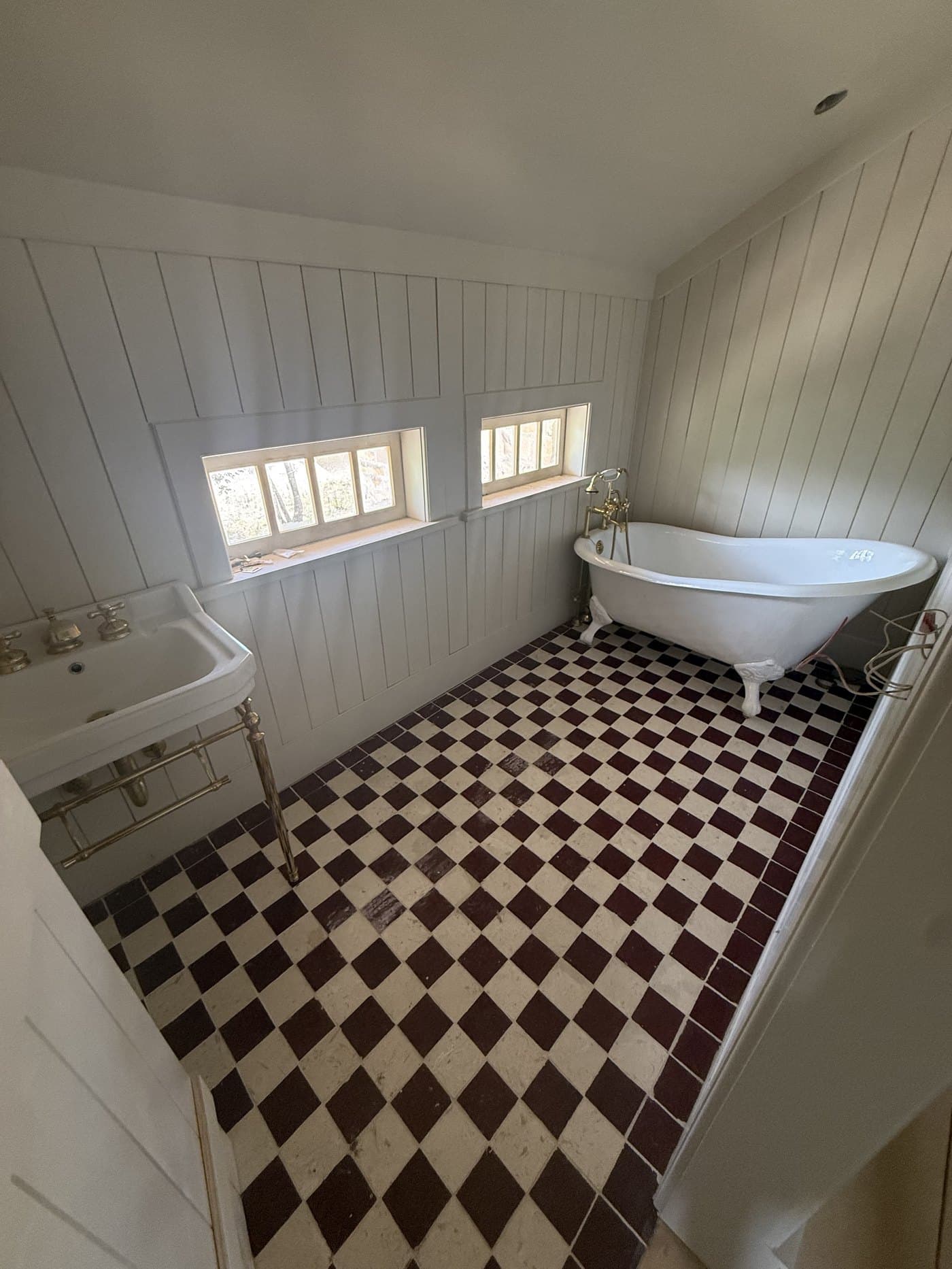 Clawfoot tub on chequered tile