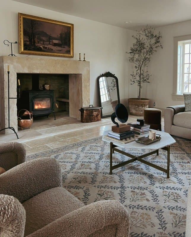 Sitting room with stone fireplace and olive tree