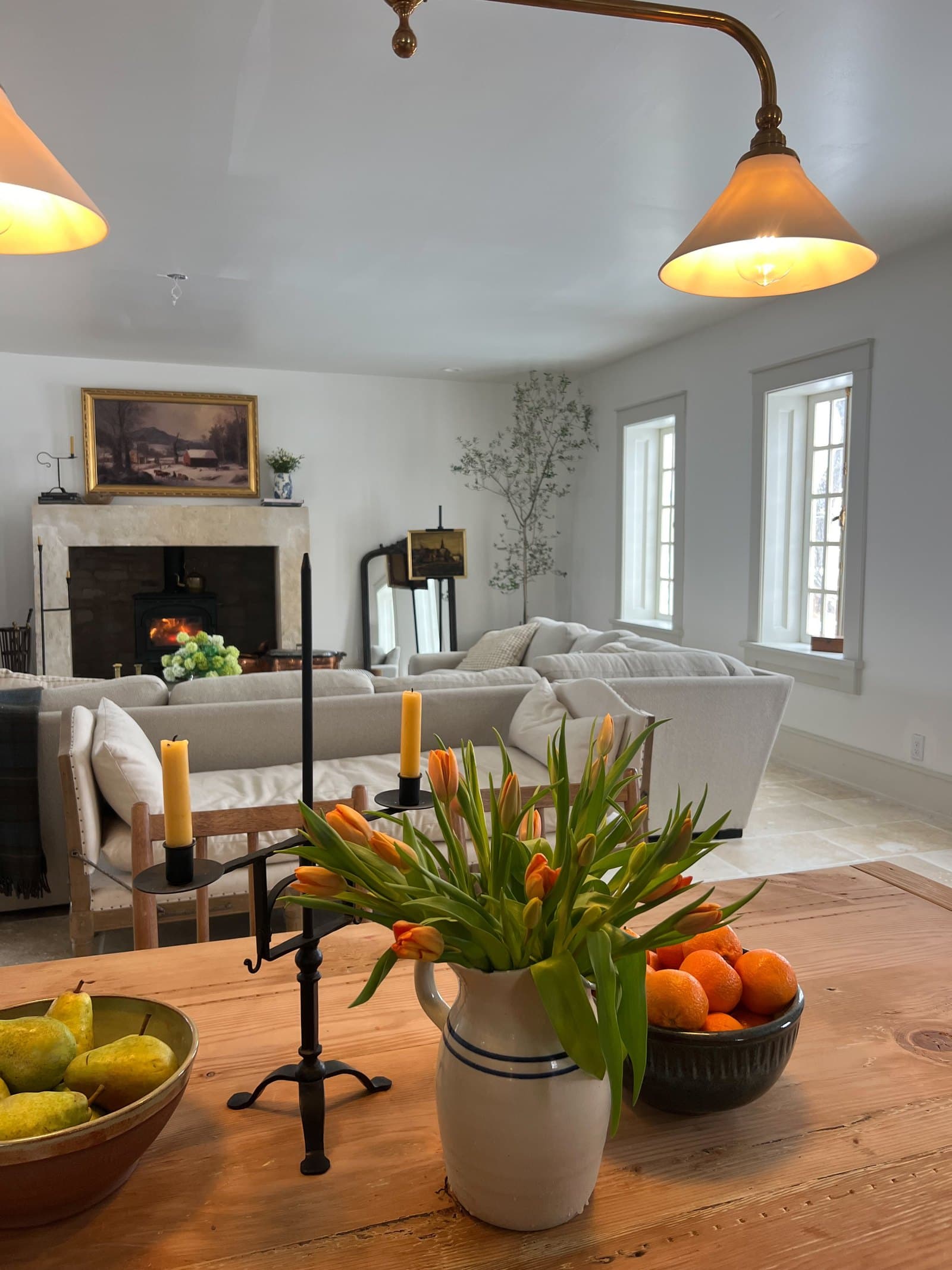 Sitting room with the fire lit and tulips on the table