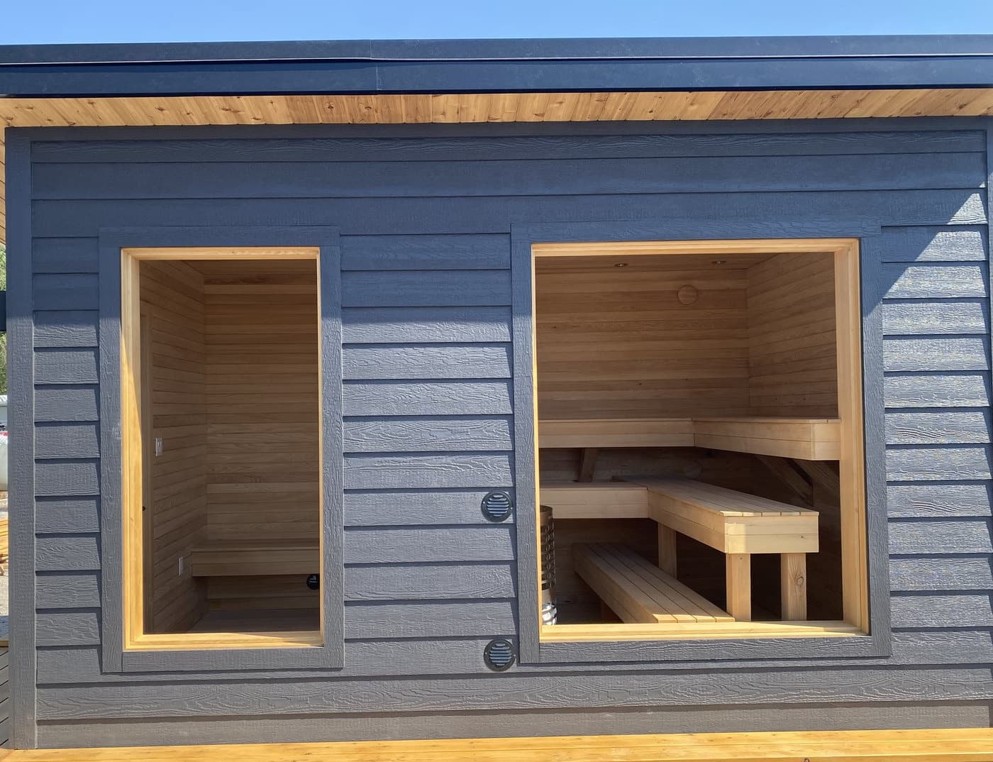 Sauna benches in cedar behind a glazed front